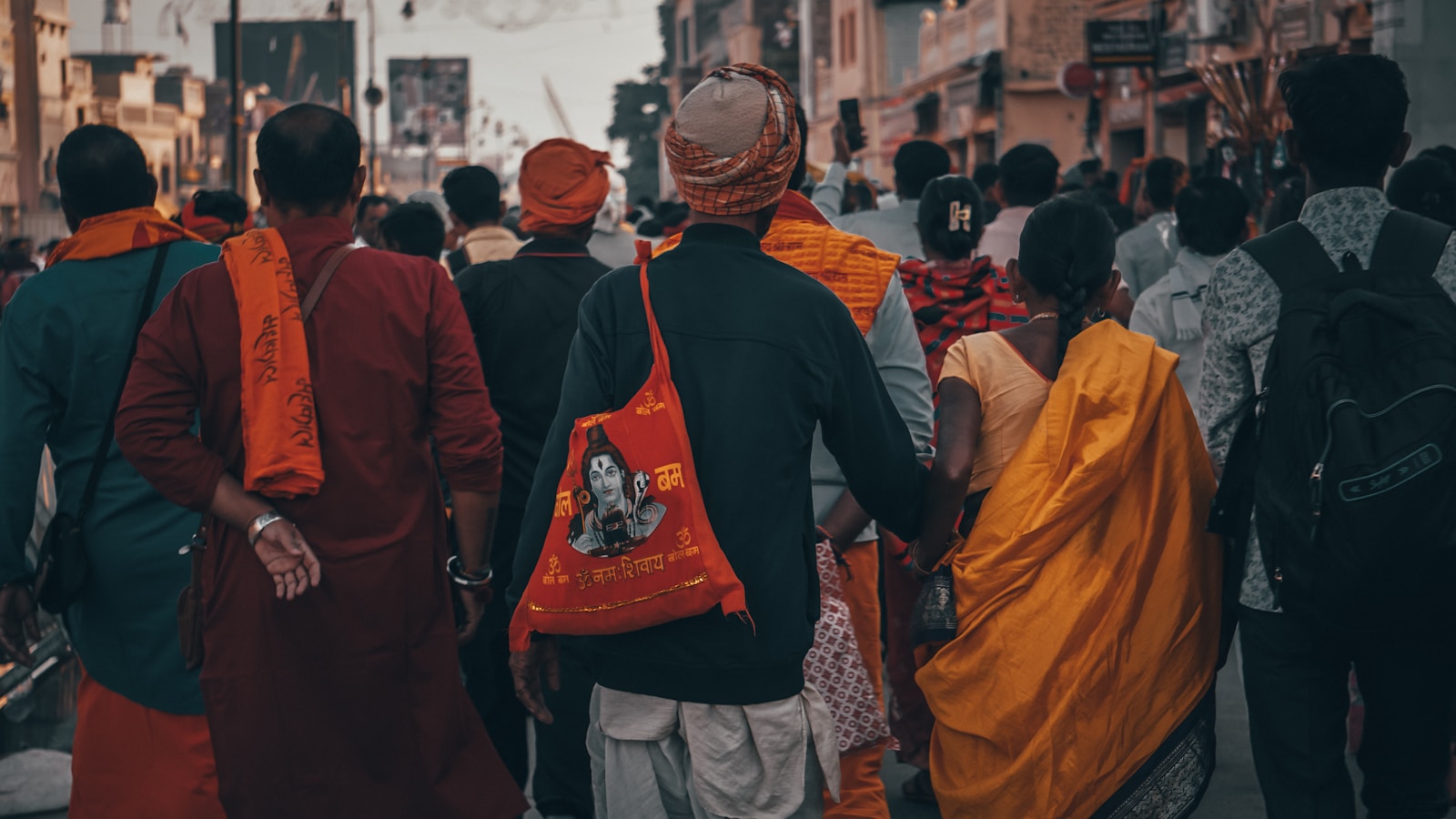 People walk down a busy, crowded street.